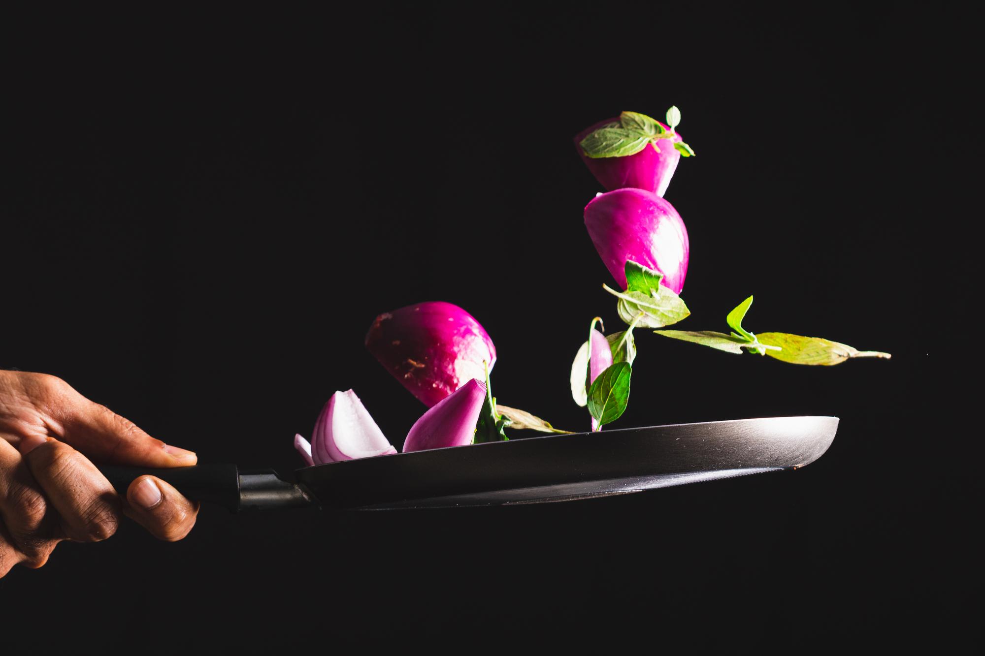 Chef plating modern dish with neon accents